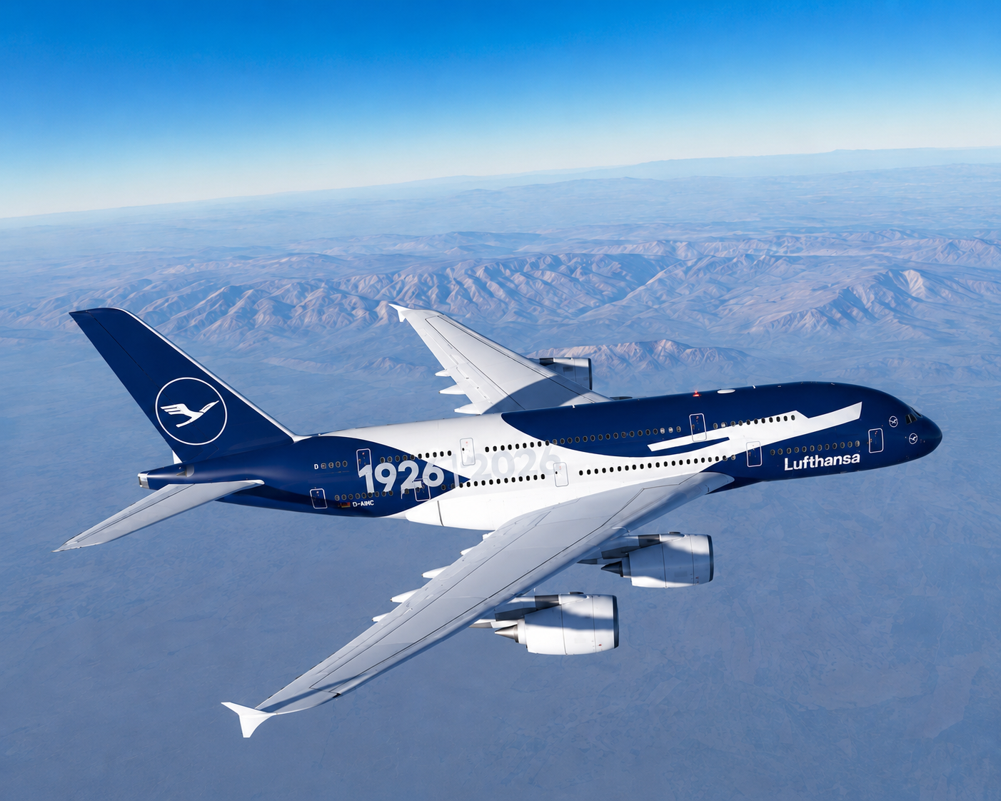 Lufthansa A380 1926–2026 livery cruising above mountain terrain